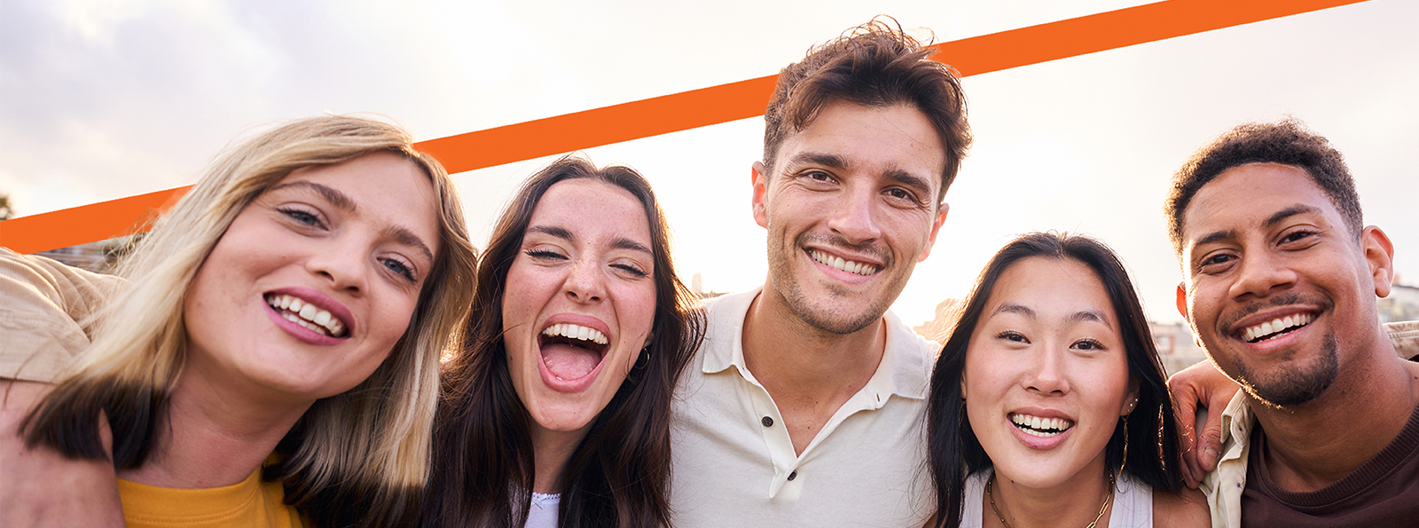 Group of five friends smiling.